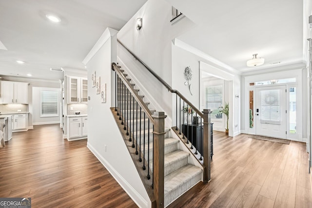 4189 Brookmont Way, Auburn, GA 30011 - entrance foyer featuring crown molding, stairs, wood finished floors, and recessed lighting
