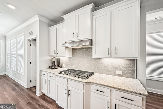4189 Brookmont Way, Auburn, GA 30011 - kitchen with stainless steel gas cooktop, under cabinet range hood, ornamental molding, white cabinets, and dark wood-type flooring