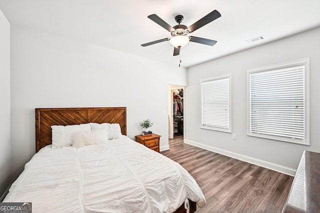 4189 Brookmont Way, Auburn, GA 30011 - bedroom featuring wood finished floors, a walk in closet, a ceiling fan, and a closet