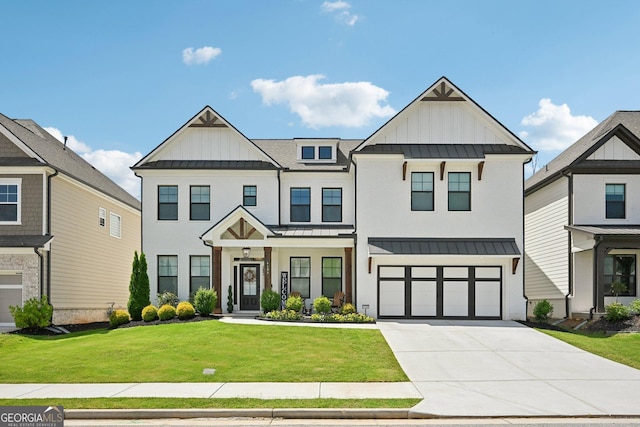 4189 Brookmont Way, Auburn, GA 30011 - view of front facade with a standing seam roof, board and batten siding, driveway, a front lawn, and a metal roof