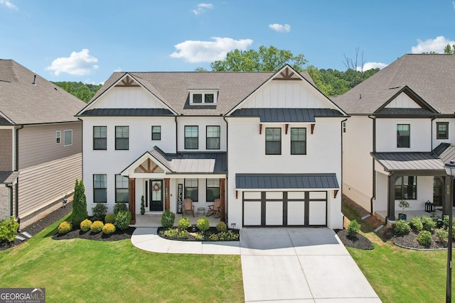 4189 Brookmont Way, Auburn, GA 30011 - view of front of property featuring a standing seam roof, driveway, a garage, a front yard, and board and batten siding