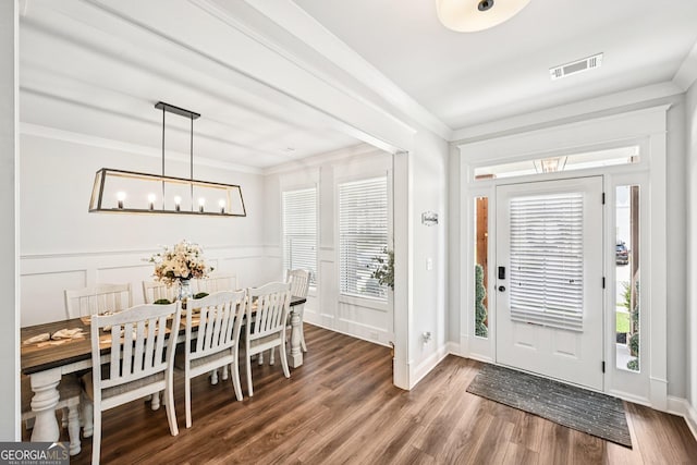 4189 Brookmont Way, Auburn, GA 30011 - entrance foyer featuring wood finished floors, a chandelier, ornamental molding, and a decorative wall