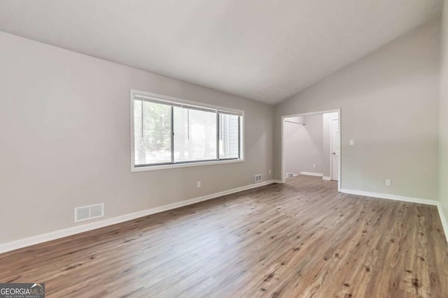 5215 Mainstreet Park Dr, Stone Mountain, GA 30088 - unfurnished bedroom with wood finished floors and lofted ceiling