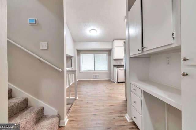 5215 Mainstreet Park Dr, Stone Mountain, GA 30088 - kitchen featuring white cabinetry, light wood finished floors, and light countertops