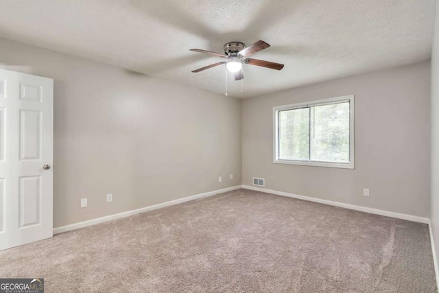 5215 Mainstreet Park Dr, Stone Mountain, GA 30088 - spare room with a ceiling fan, carpet, and a textured ceiling