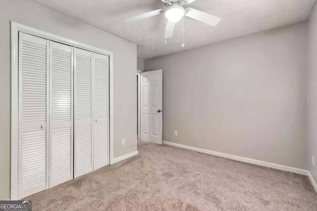 5215 Mainstreet Park Dr, Stone Mountain, GA 30088 - unfurnished bedroom featuring carpet flooring, a closet, and ceiling fan
