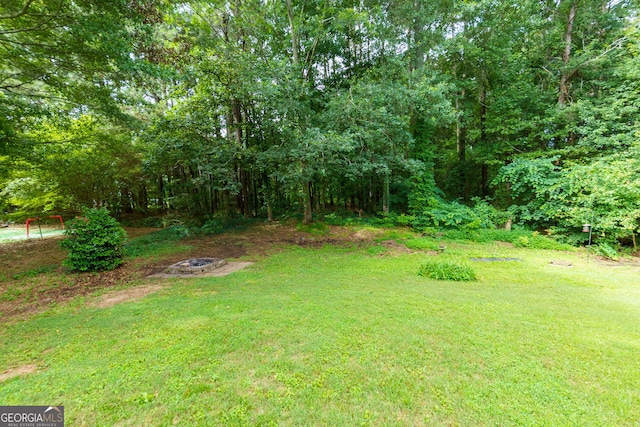 552 Caseys Xing, Winder, GA 30680 - view of green lawn with a fire pit