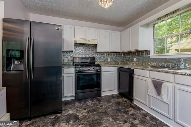 552 Caseys Xing, Winder, GA 30680 - kitchen featuring appliances with stainless steel finishes, under cabinet range hood, tasteful backsplash, a textured ceiling, and white cabinetry