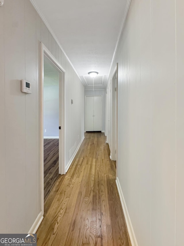 314 Pine St, Barnesville, GA 30204 - hallway featuring attic access, ornamental molding, wood finished floors, and a decorative wall