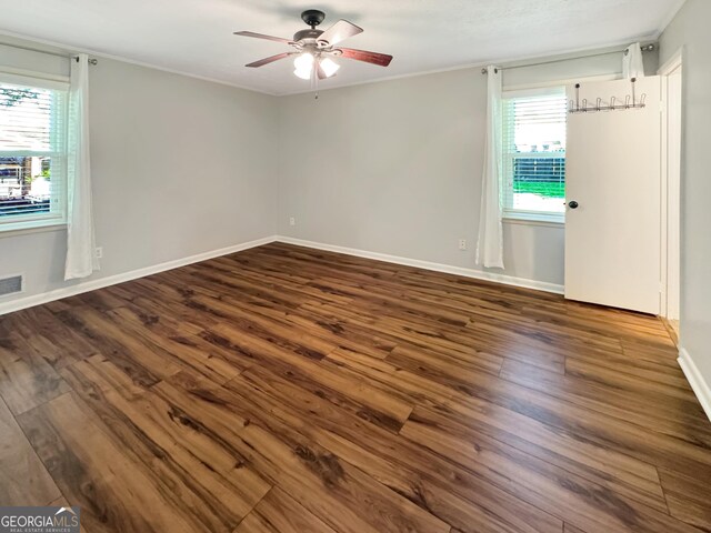 314 Pine St, Barnesville, GA 30204 - empty room with plenty of natural light, ceiling fan, dark wood-type flooring, and ornamental molding