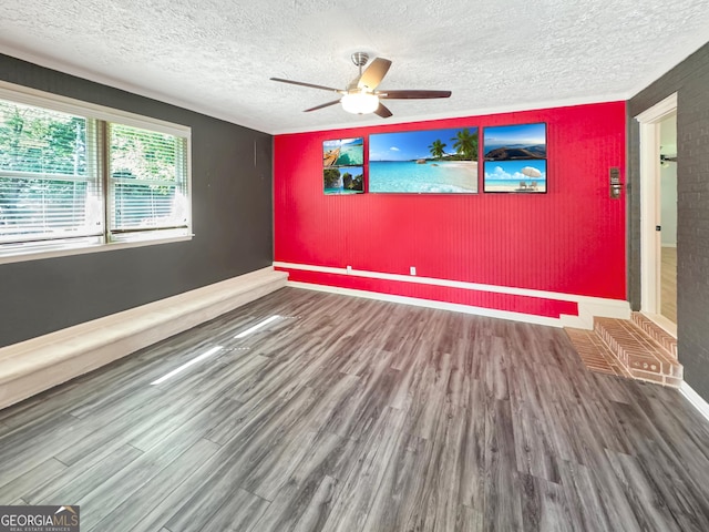 314 Pine St, Barnesville, GA 30204 - unfurnished room with wood finished floors, ceiling fan, an accent wall, and a textured ceiling