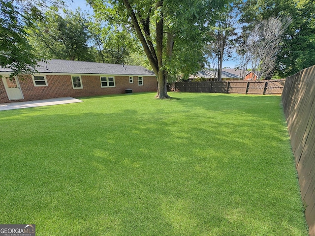 314 Pine St, Barnesville, GA 30204 - fenced backyard with a patio area