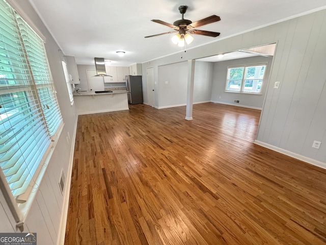 314 Pine St, Barnesville, GA 30204 - unfurnished living room with wood finished floors, a ceiling fan, and ornamental molding