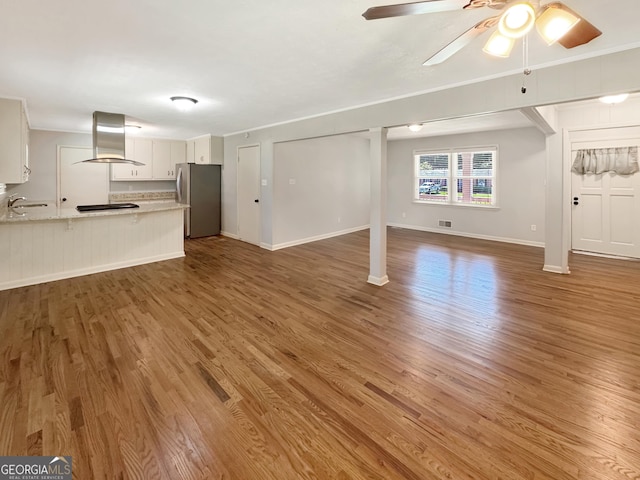 314 Pine St, Barnesville, GA 30204 - unfurnished living room featuring wood finished floors and ceiling fan