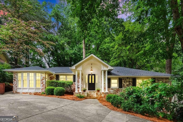 5114 N Ivy Rd NE, Atlanta, GA 30342 - view of front facade featuring driveway and stone siding