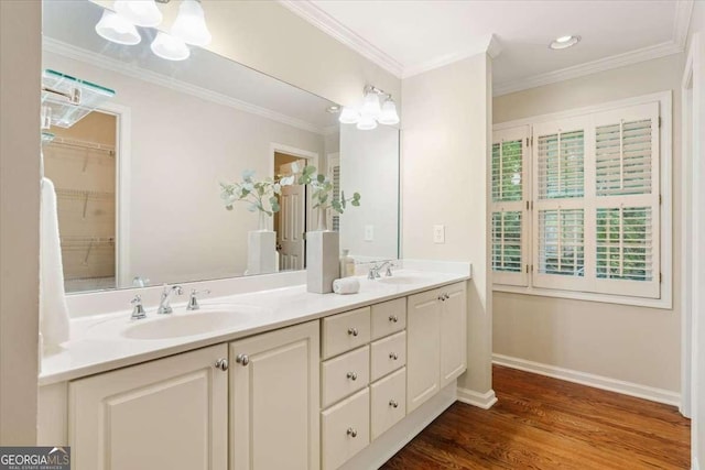 5114 N Ivy Rd NE, Atlanta, GA 30342 - full bathroom featuring double vanity, wood finished floors, crown molding, a chandelier, and recessed lighting