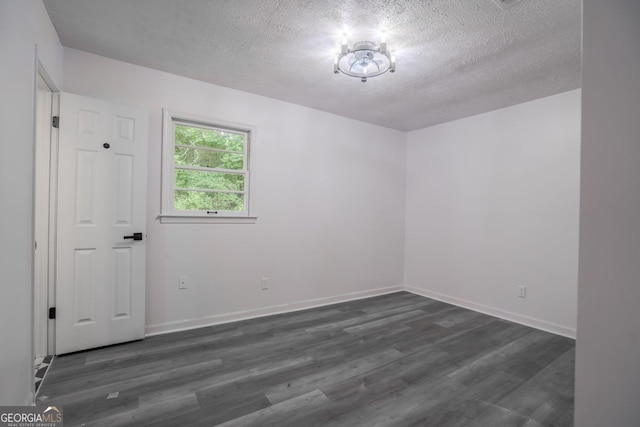 3570 Briar Dr, Lithia Springs, GA 30122 - unfurnished room featuring a textured ceiling and dark wood-style flooring