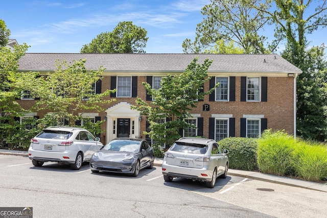 1101 Collier Rd NW Unit P2, Atlanta, GA 30318 - view of front of property featuring uncovered parking, brick siding, and a shingled roof