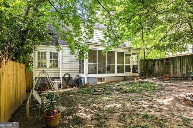 348 7th St NE, Atlanta, GA 30308 - rear view of house featuring a sunroom, a fenced backyard, and a shingled roof
