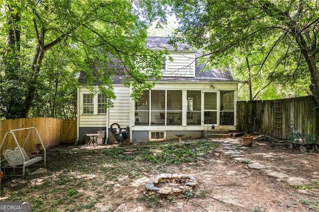348 7th St NE, Atlanta, GA 30308 - back of property with a sunroom, a fenced backyard, and roof with shingles