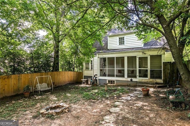 348 7th St NE, Atlanta, GA 30308 - rear view of house featuring a sunroom, a fenced backyard, a fire pit, and roof with shingles