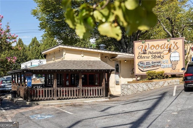 348 7th St NE, Atlanta, GA 30308 - view of front facade featuring uncovered parking and a shingled roof