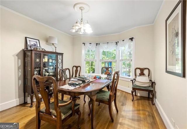 348 7th St NE, Atlanta, GA 30308 - dining space featuring a chandelier, light wood finished floors, and crown molding