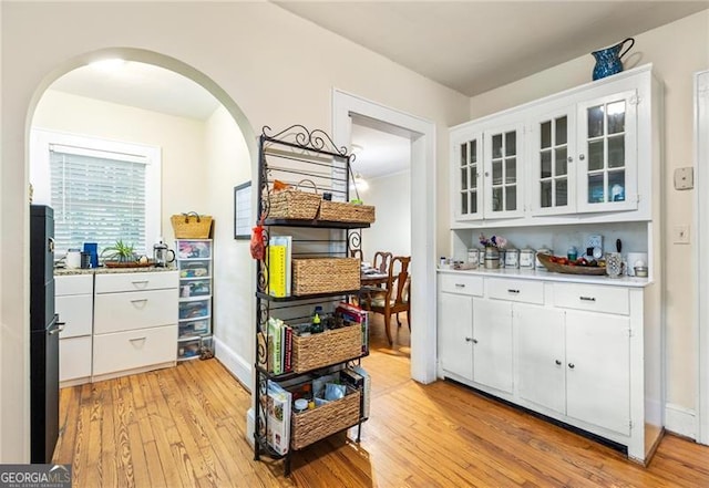 348 7th St NE, Atlanta, GA 30308 - bar featuring light wood-style flooring, arched walkways, and freestanding refrigerator