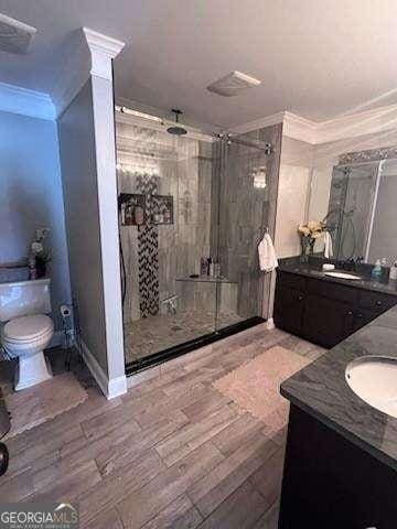 3560 Elinburg Dr, Buford, GA 30519 - bathroom featuring crown molding, vanity, a shower stall, and wood finished floors