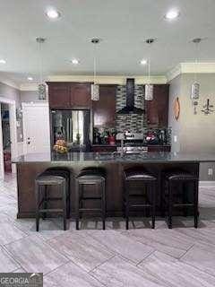 3560 Elinburg Dr, Buford, GA 30519 - bar with wall chimney range hood, freestanding refrigerator, recessed lighting, crown molding, and hanging light fixtures