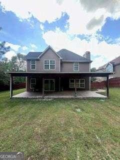 3560 Elinburg Dr, Buford, GA 30519 - rear view of property with a patio area, a lawn, and a chimney