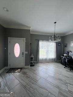 3560 Elinburg Dr, Buford, GA 30519 - entrance foyer featuring a chandelier and crown molding