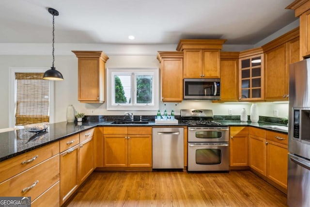 261 Elmira Pl NE, Atlanta, GA 30307 - kitchen with appliances with stainless steel finishes, recessed lighting, decorative light fixtures, dark stone counters, and wood finished floors