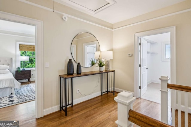 261 Elmira Pl NE, Atlanta, GA 30307 - corridor featuring wood finished floors, crown molding, and an upstairs landing