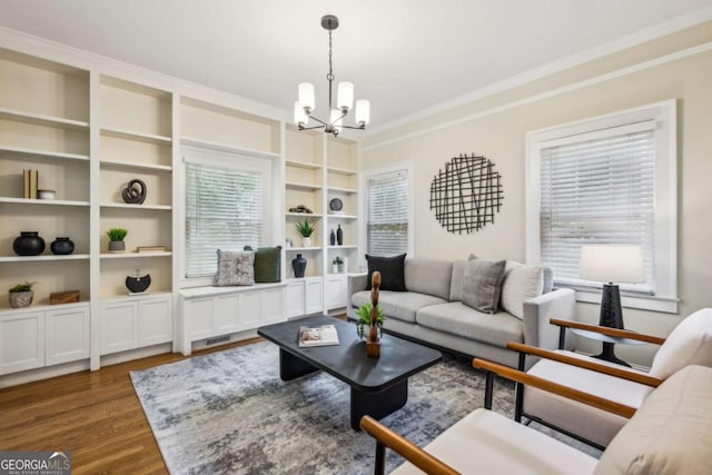 261 Elmira Pl NE, Atlanta, GA 30307 - living room featuring a chandelier, ornamental molding, dark wood-style floors, and built in shelves