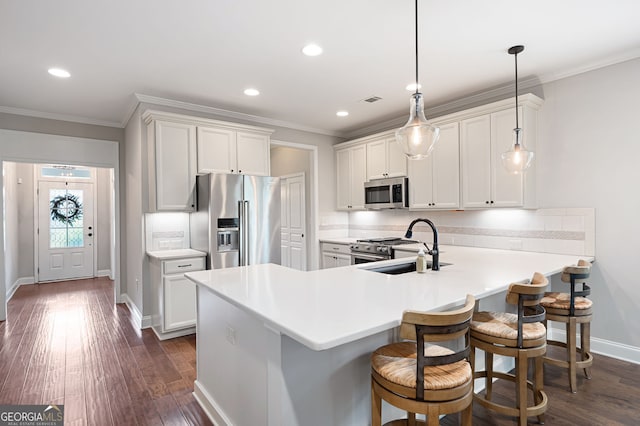 214 Misty View Dr, Canton, GA 30114 - kitchen featuring appliances with stainless steel finishes, crown molding, light countertops, dark wood-type flooring, and a peninsula