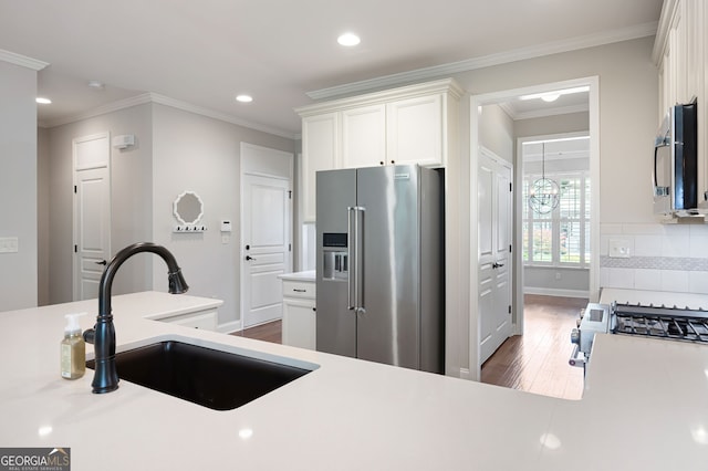 214 Misty View Dr, Canton, GA 30114 - kitchen featuring stainless steel appliances, wood finished floors, white cabinetry, light countertops, and ornamental molding
