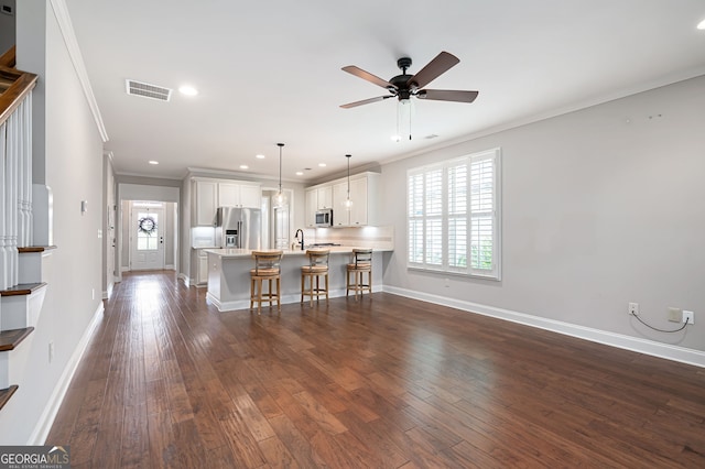 214 Misty View Dr, Canton, GA 30114 - kitchen featuring stainless steel appliances, crown molding, a peninsula, a breakfast bar, and ceiling fan