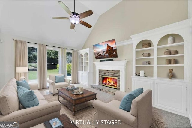 4206 Moccasin Trl, Woodstock, GA 30189 - living room featuring high vaulted ceiling, ceiling fan, a stone fireplace, and built in shelves