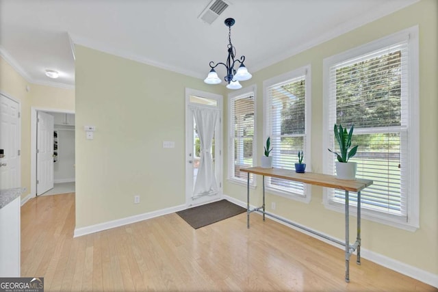 4206 Moccasin Trl, Woodstock, GA 30189 - foyer entrance featuring crown molding, plenty of natural light, wood finished floors, and a chandelier