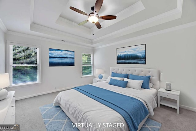 4206 Moccasin Trl, Woodstock, GA 30189 - carpeted bedroom featuring a tray ceiling, ornamental molding, multiple windows, and a ceiling fan