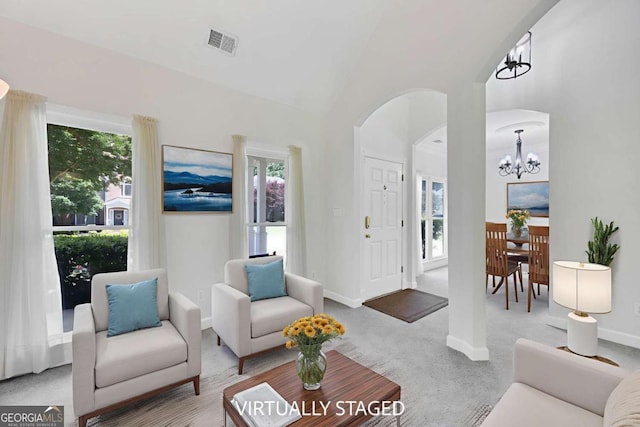 4206 Moccasin Trl, Woodstock, GA 30189 - living room with a chandelier, carpet floors, plenty of natural light, arched walkways, and lofted ceiling