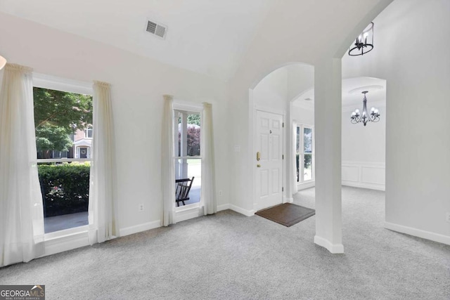 4206 Moccasin Trl, Woodstock, GA 30189 - entrance foyer with carpet flooring, a chandelier, arched walkways, and vaulted ceiling