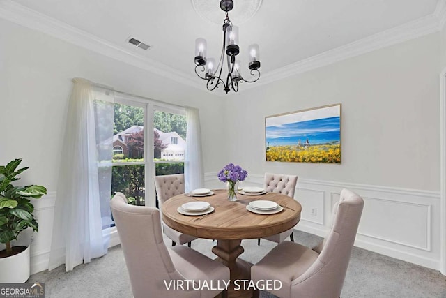 4206 Moccasin Trl, Woodstock, GA 30189 - dining space with light carpet, a chandelier, ornamental molding, wainscoting, and a decorative wall