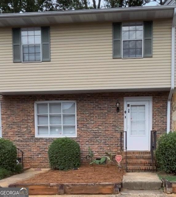 501 Carlton Rd # 3B, Palmetto, GA 30268 - townhome / multi-family property featuring entry steps and brick siding