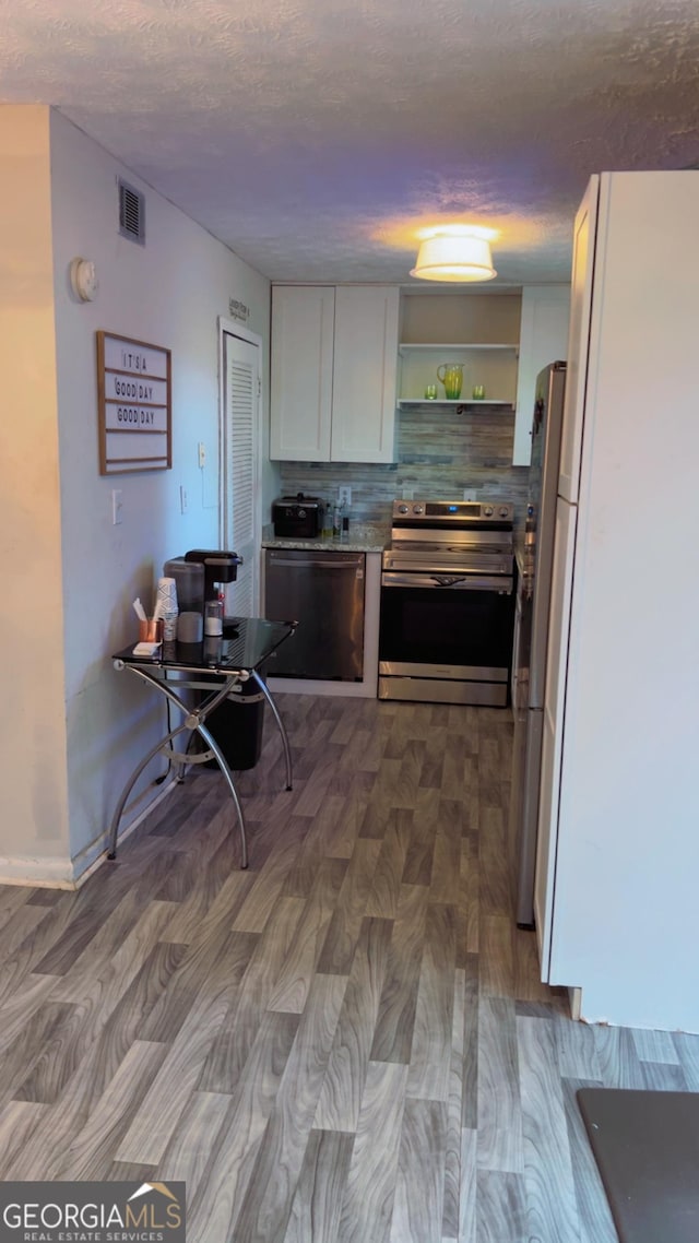 501 Carlton Rd # 3B, Palmetto, GA 30268 - kitchen featuring stainless steel appliances, white cabinetry, open shelves, a textured ceiling, and decorative backsplash