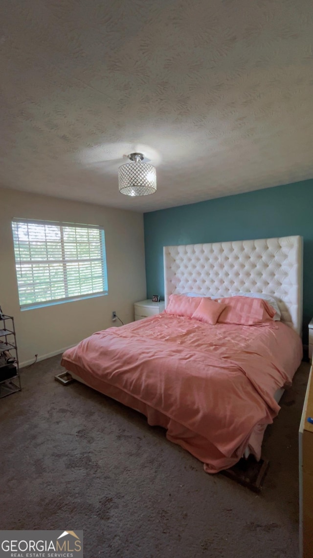 501 Carlton Rd # 3B, Palmetto, GA 30268 - carpeted bedroom with a textured ceiling and baseboards