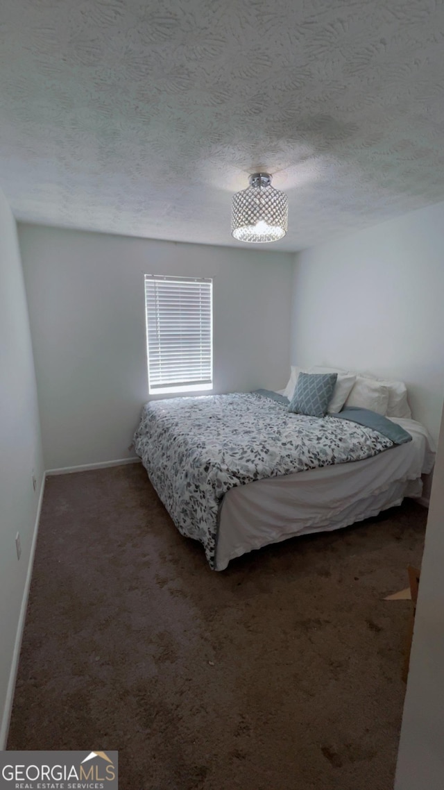 501 Carlton Rd # 3B, Palmetto, GA 30268 - carpeted bedroom featuring a textured ceiling