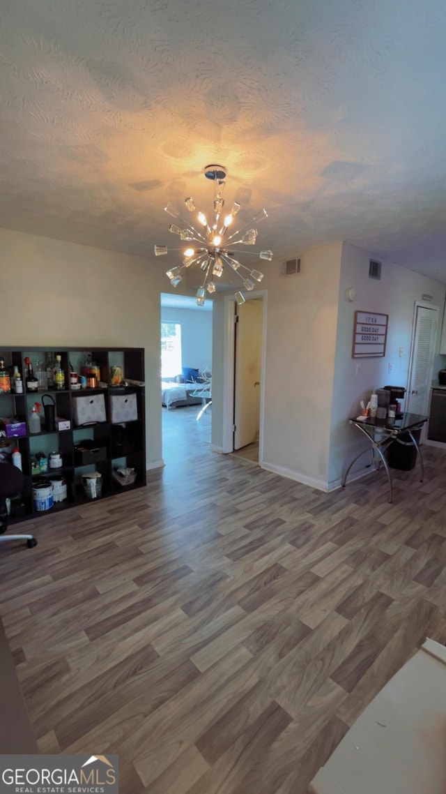501 Carlton Rd # 3B, Palmetto, GA 30268 - living room with a chandelier, a textured ceiling, and wood finished floors