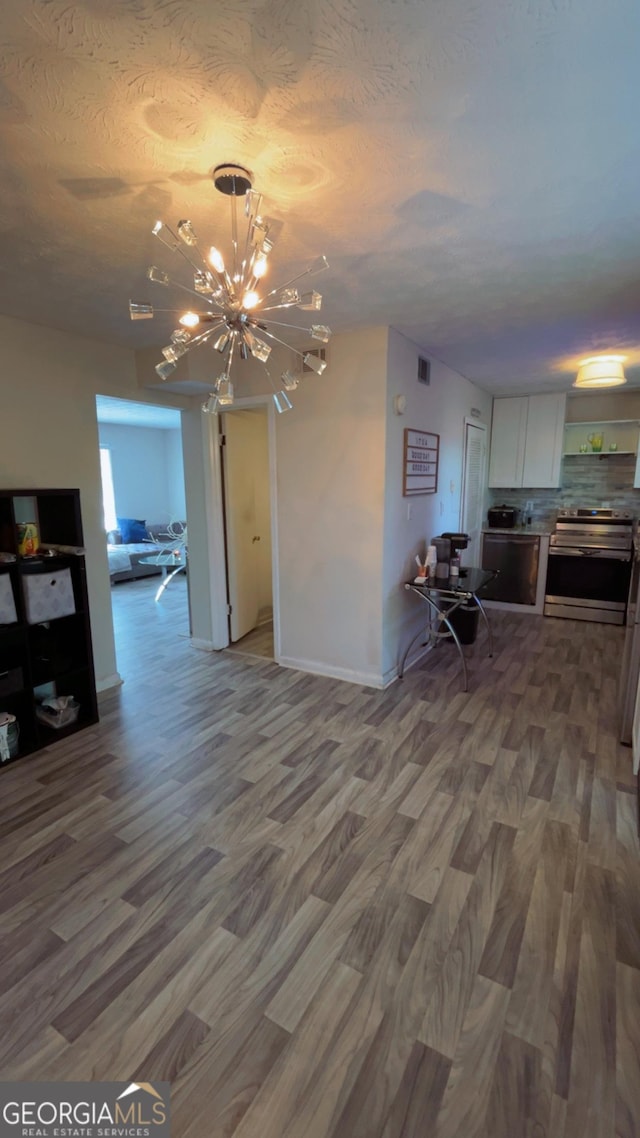 501 Carlton Rd # 3B, Palmetto, GA 30268 - living area featuring wood finished floors, a chandelier, and a textured ceiling